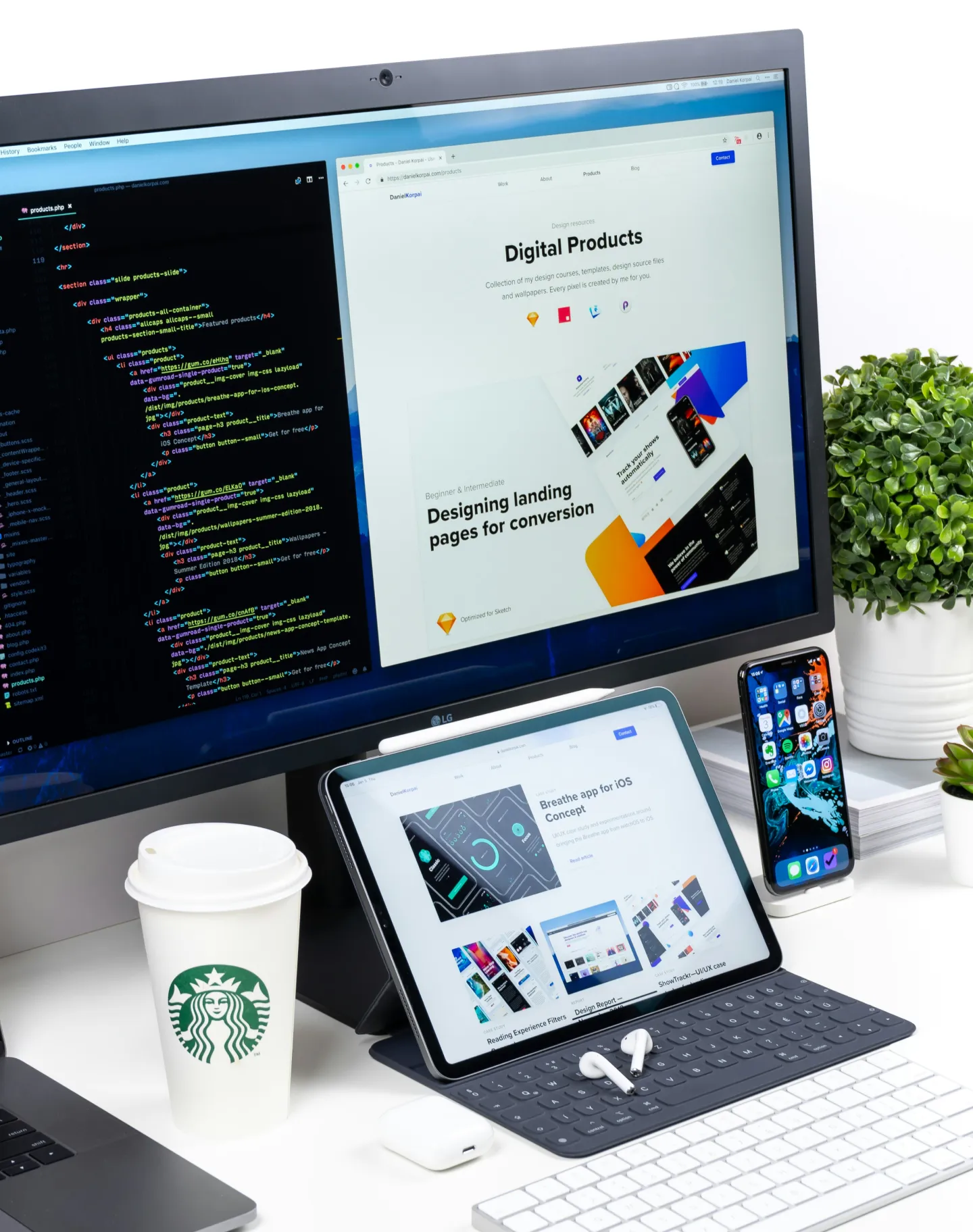 Designer workspace with code, web design and mobile mockups across multiple screens